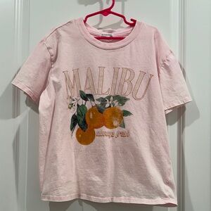 Eyeshadow Light Pink Malibu Tee with Orange Design